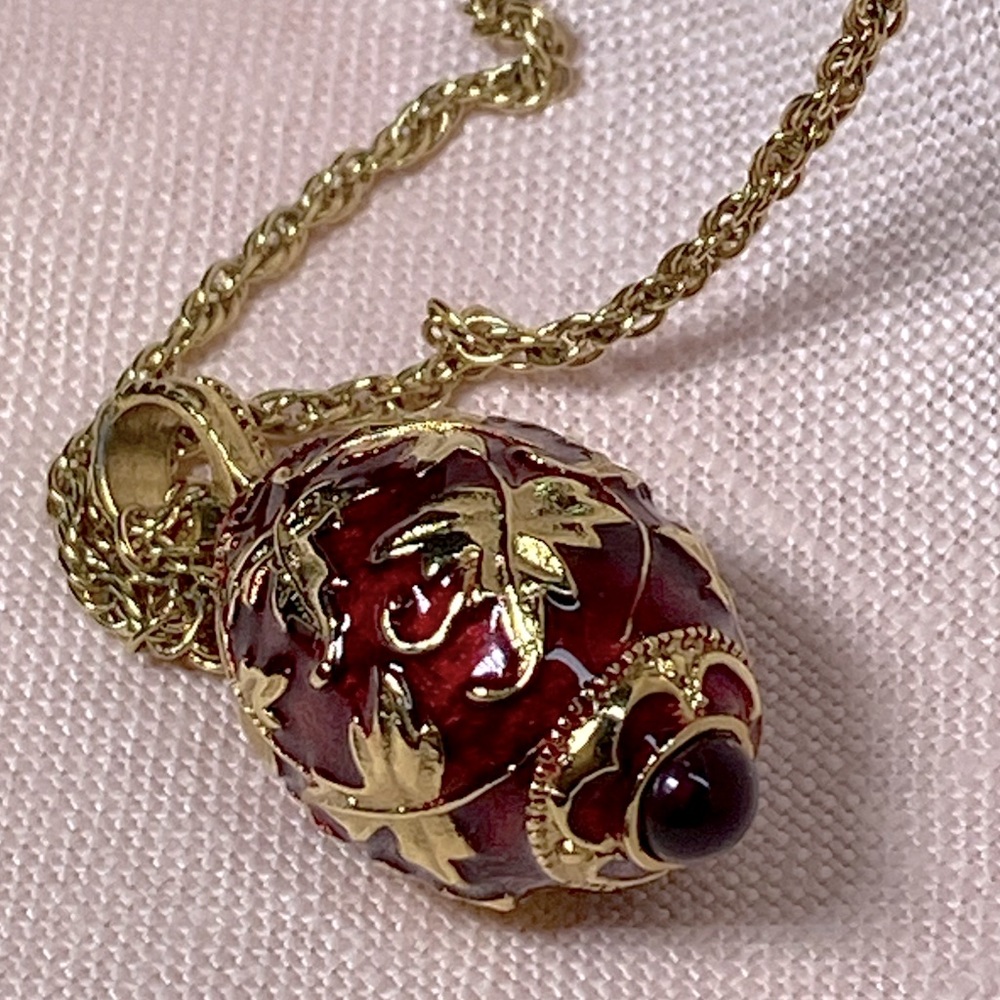 1928 goldtone necklace with beautiful ruby glass gilded egg pendant.